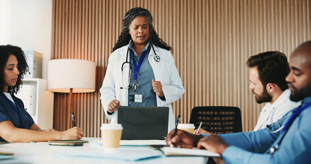 Speaker, woman and laptop with doctors in hospital for meeting, surgery schedule and healthcare. Digital records, planning and medical with people in clinic for consulting, collaboration and nurses