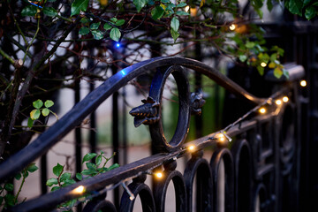 Metal fence panel with string lights changing position