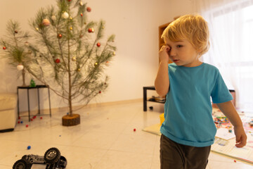 Tired child rubbing eye after playing holidays