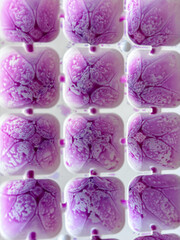 Purple ice cubes texture in honeycomb pattern tray