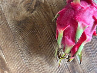 Vertical view of dragon fruit stem and vibrant pink skin