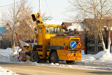Large Yellow Industrial Snow Blower Clearing City Streets