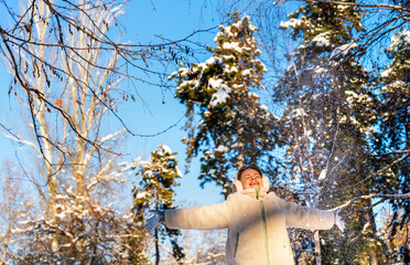 Woman enjoying snowy forest in winter