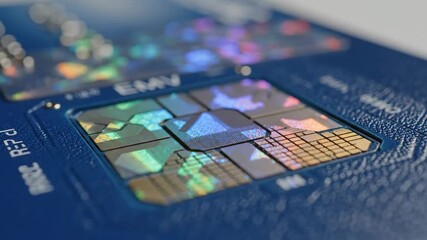 Close-up of a blue credit card EMV chip. Holographic patterns shimmer and change colors. Modern financial technology and secure payment concept - Powered by Adobe