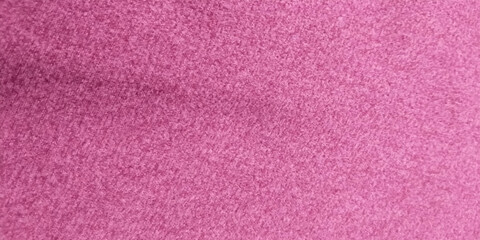 Fototapeta premium Close-up macro image of a pink textured fabric surface with fine fibers and subtle grain. Abstract background with soft pastel tones, ideal for use in design projects,