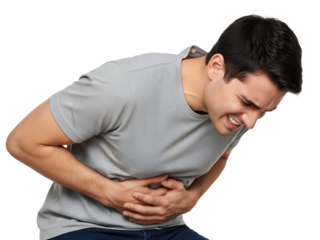 Young adult male suffering from intense abdominal pain clutches his stomach with both hands, grimacing deeply in discomfort due to a severe digestive health issue, requiring urgent relief.