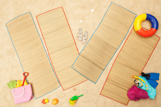 Colorful beach toys and mats arranged in artificial beach scene studio
