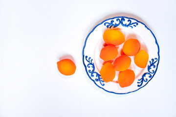 Chinese Preserved Fruit Fresh red yellow Sweet Peach on a decorative plate with intricate blue patterns, showcasing vibrant colors and natural textures, perfect for culinary 