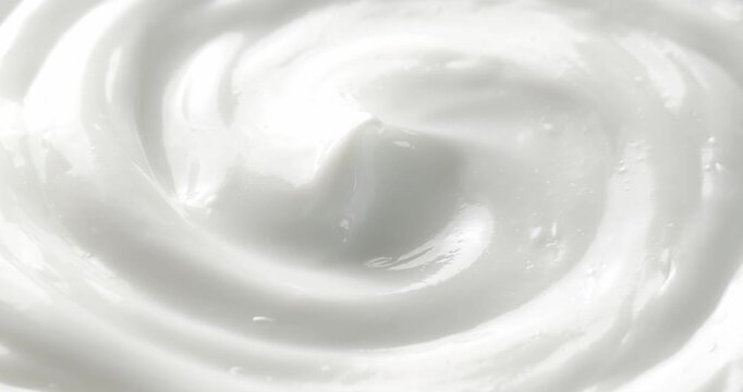 Cosmetic smears of creamy texture. Cosmetic skin cream. Beauty skincare product sample. Close-up footage of cream texture on rotating table