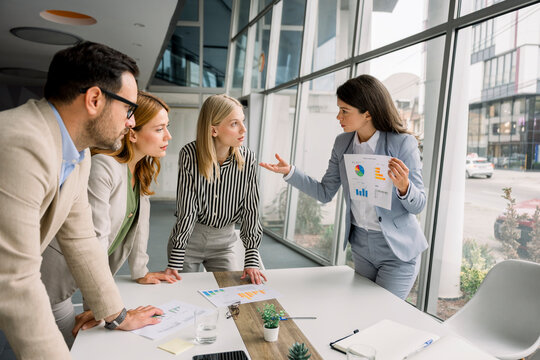Business team discussing project with charts in modern office