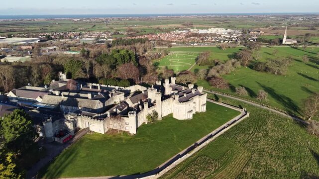 Stunning medieval Bodelwyddan Castle drone anti-clockwise rotate from far on a sunny winter day, North Wales, UK