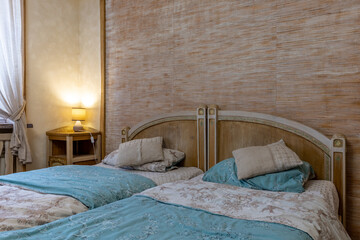 Cozy rustic bedroom interior with wooden beds and warm lamp light