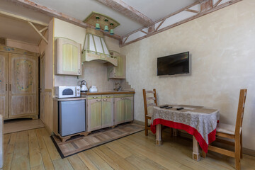 Rustic studio apartment interior with kitchenette and dining area