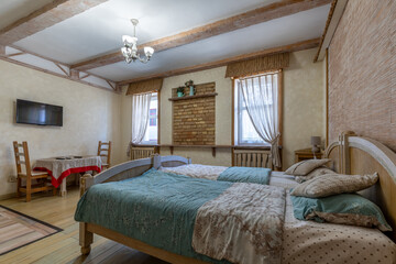 Rustic bedroom interior with brick wall niche and wooden furniture