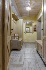 Rustic wooden hallway interior with hand-painted furniture