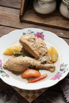Ayam Masak Kurma is a traditional Malay chicken curry cooked with aromatic spices coconut milk and kurma seasoning offering a rich mildly spiced flavor commonly served for family meals and festive occ