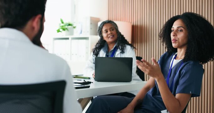 Woman, talking and doctors in meeting, healthcare and feedback for hospital schedule. People, medical service and employees in clinic, discussion or review for medicare support and compliance agenda