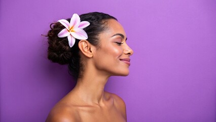A woman with a flower in her hair and a purple background
