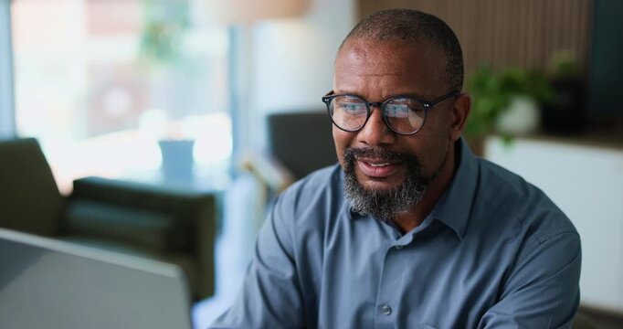 Reading, mature or black man with glasses in office, review banking transaction or process deposit. Bookkeeping, tech reflection or account clerk smile with invoice approval, finance admin or specs