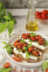 Italian sandwiches with grilled tomatoes, burrata cheese and pesto	