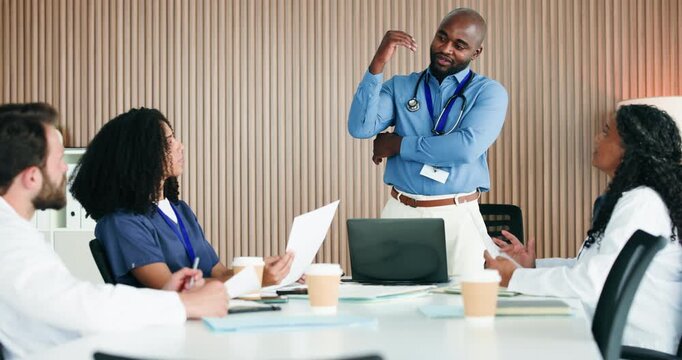 Discussion, manager or doctors with paper in boardroom, admin or operational planning for medical practice. Private clinic, healthcare committee or director brainstorming with team, people or laptop