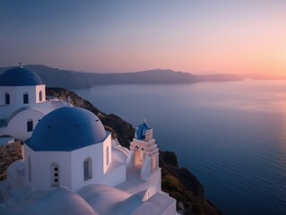 Village with iconic blue domed churches and white cycladic houses perched on cliffs overlooking the aegean at sunset, evoking serene mediterranean beauty and romance