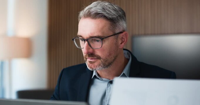 Businessman, glasses and document in office with laptop for finance proposal, budget info and email. Mature person, reading and evaluation in workplace with computer, financial paperwork and report.