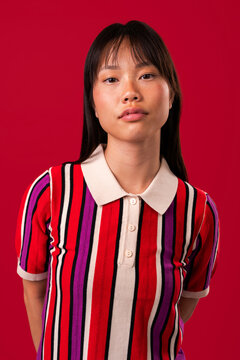 Beautiful asian woman portrait, asian woman posing in studio with colorful striped shirt