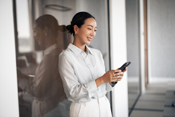 Businesswoman smiling and using smartphone for communication