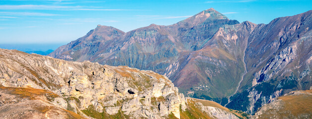 Mountain ridge with blue cloudy sky. Mountain landscape with day sky and clouds. Grossglockner High Alpine Road. Austria