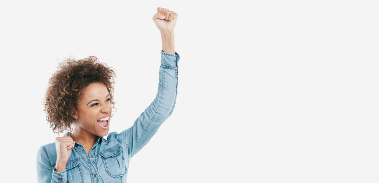 Woman, fist pump and celebration in studio with success, goals and mockup space on white background. African person, winner and scream with achievement, happy and excited for prize announcement