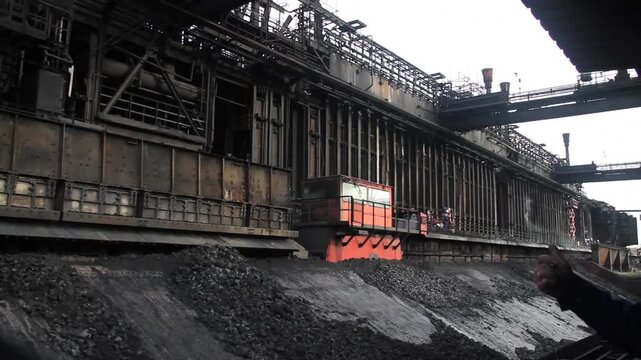 Coke oven plant in operation producing hard but reactive metallurgical coke for blast furnace use.