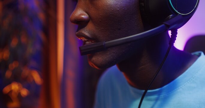 Man in headphones with a microphone playing computer video games - Powered by Adobe