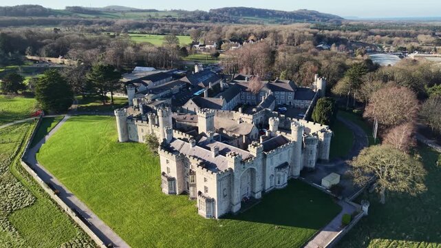 Stunning medieval Bodelwyddan Castle fast drone anti-clockwise rotate on a sunny winter day, North Wales, UK