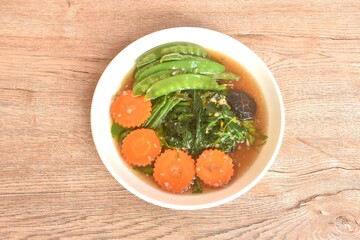 fried mixed vegetable dressing sesame oil and soy sauce with chop garlic on plate