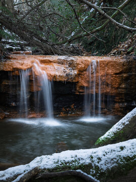 Marline valley waterfall during winter snow on the high weald near Hastings east Sussex south east England UK