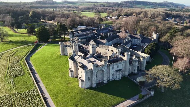 Stunning medieval Bodelwyddan Castle fast drone clockwise rotate from near on a sunny winter day, North Wales, UK