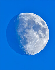 Waxing Gibbous Moon Against Clear Blue Daytime Sky Close-up
