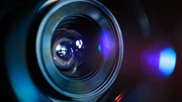 Camera lens captures vibrant light reflections and intricate details, showcasing the optical components and textures while focusing on the lens surface and surrounding elements