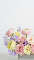 Pastel flower bouquet with roses and ranunculus on white background. Springtime floral arrangement for greeting card. Wedding blossom.