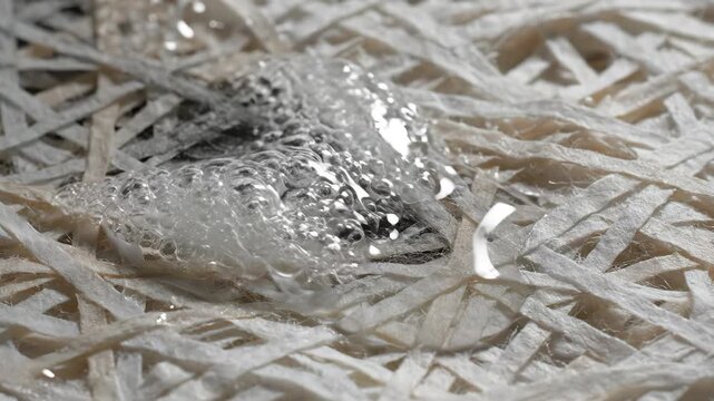 Water flowing onto shredded paper