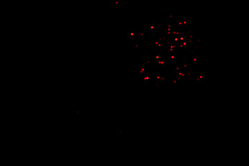 Red blurred bokeh lights on black background. Glitter sparkle confetti for celebrate. Overlay for your design