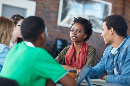 Meeting, people or college students in class with tech, knowledge and discussion for group project. Academic, learners and conversation in university for assignment, collaboration and study together.