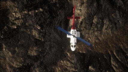 A bright helicopter flies above rugged, rocky landscape under a clear blue sky. Its red and white colors catch the light as it surveys the terrain below, showcasing aerial activity in nature. © icetray