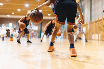 Youth Basketball Training Session Indoors.  Kids Practicing Dribbling, Movement and Team Sports Skills in Gym