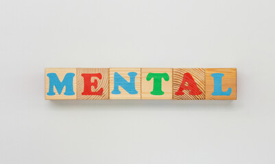 Wooden blocks in a row spelling out Mental