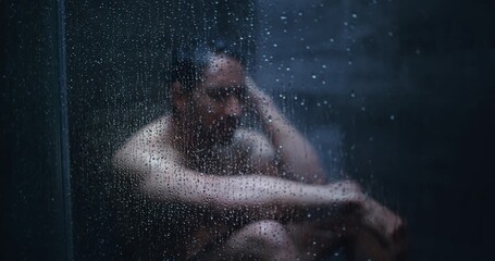 Shower, thinking and man with depression in home, mental health and remember memory for despair. Glass, grief and frustrated person overwhelmed by loss, negative perspective or reflection in bathroom