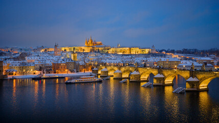 Obraz premium High Resolution Panorama Picture of Winter Snowy Prague Old Town with Prague Castle and Charles Bridge above River Vltava during Sunset , Czech republic