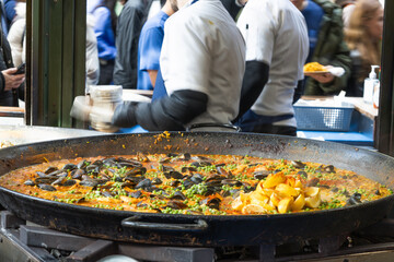 Traditional Spanish Seafood Paella at a Busy Street Food Market
