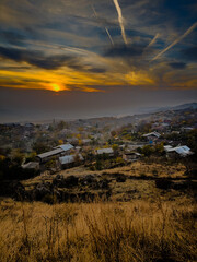 A beautiful sunset in Armenia, showing a stunning landscape of mountains, fields, forests and a shining sky. High quality photo